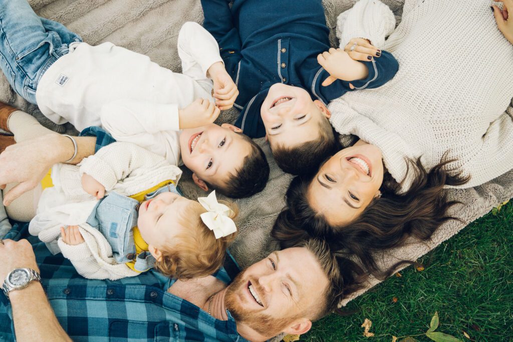 Family Session on the ground smiling